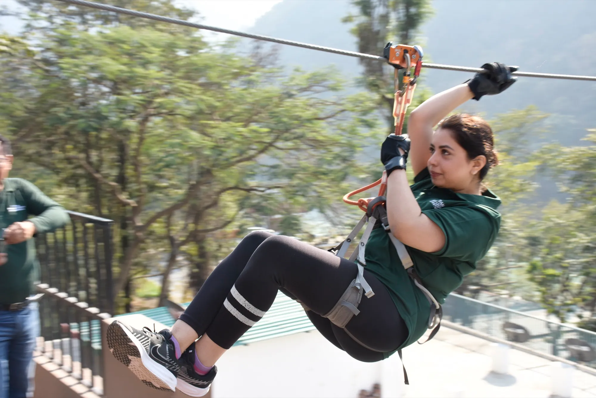 Zipliner flying through the forest canopy above the Ganges