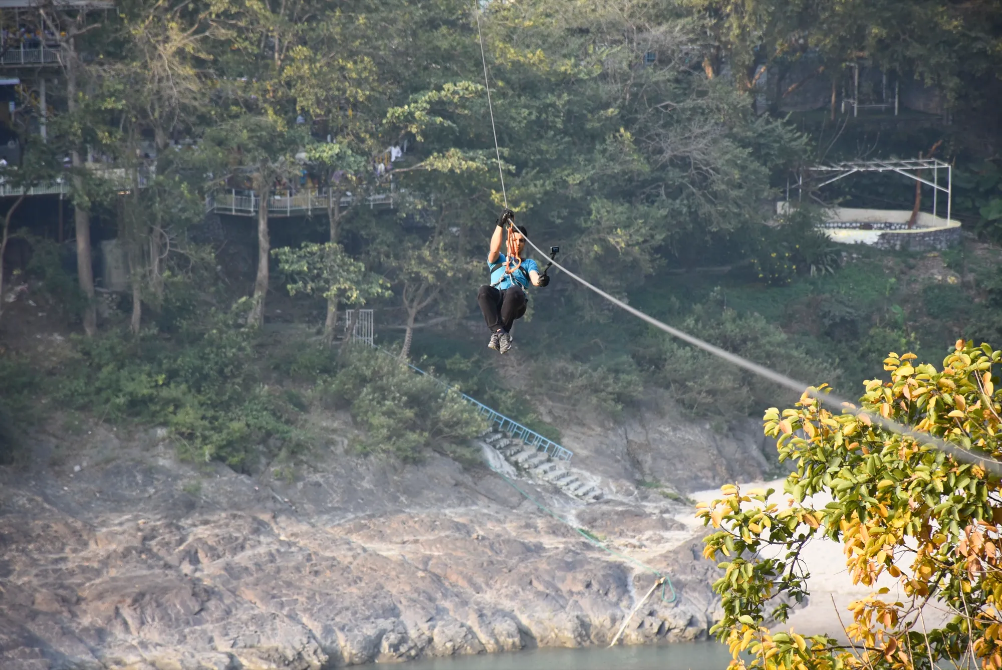 Zipliner launching from the platform above the Ganges