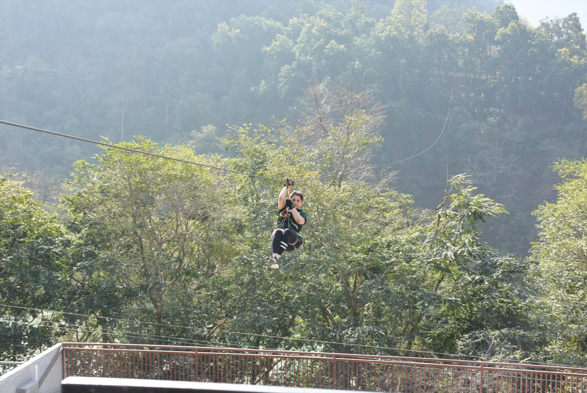 A guest launching from the zipline platform